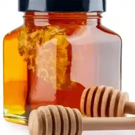 Jars of golden local honey with honeycomb