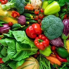 Freshly harvested green vegetables and carrots